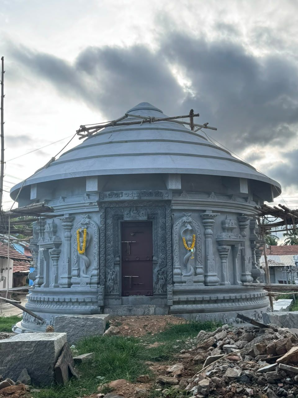 Small domed stone shrine with fully carved outer walls
