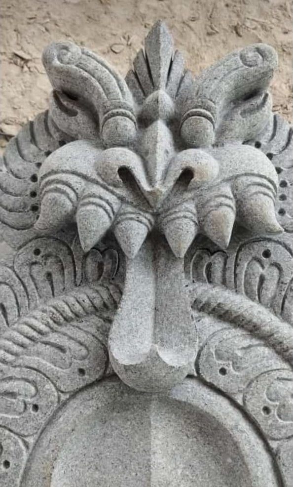 Close detail of a kirtimukha face carved above a lintel