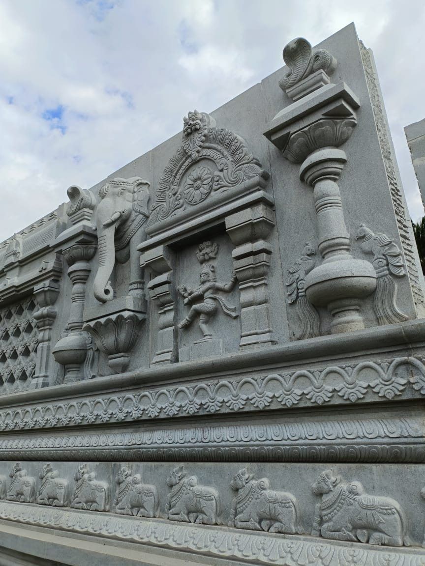 Temple wall course carved with an elephant head, Nataraja niche and nandi frieze