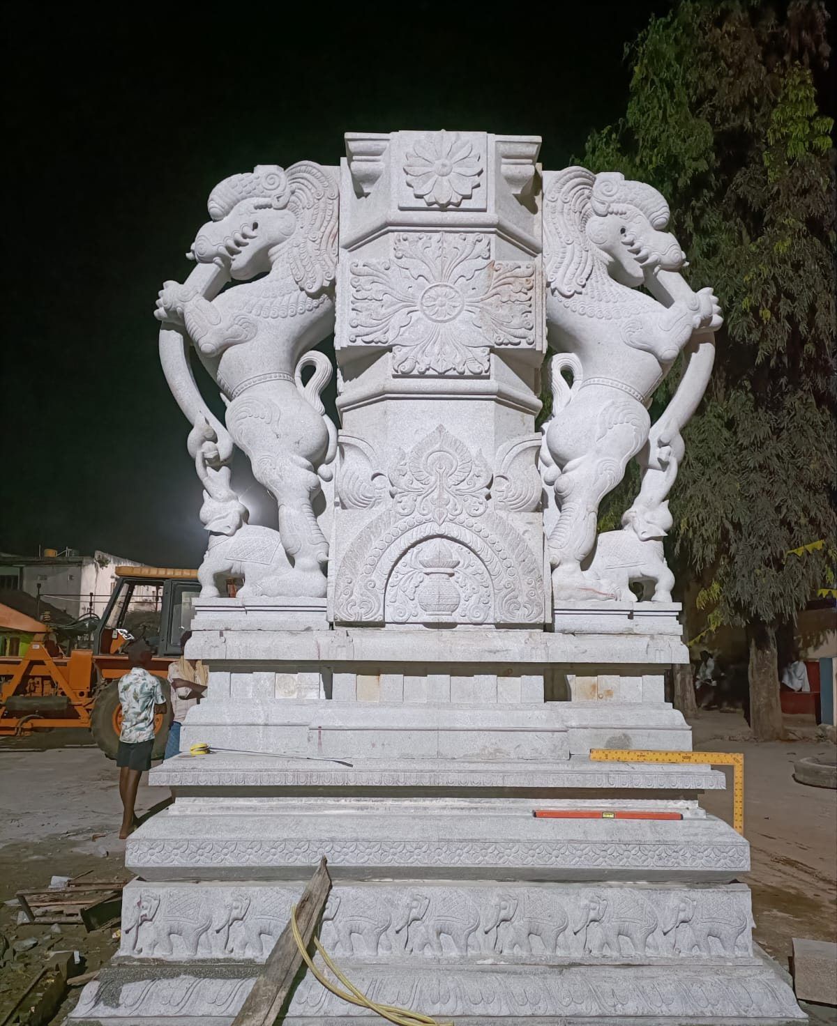 Carved granite flagstaff base with elephant and yali figures