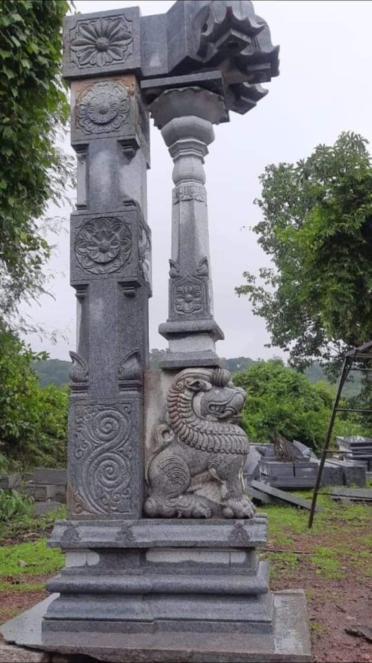 Granite pillar carved with a yali at its base