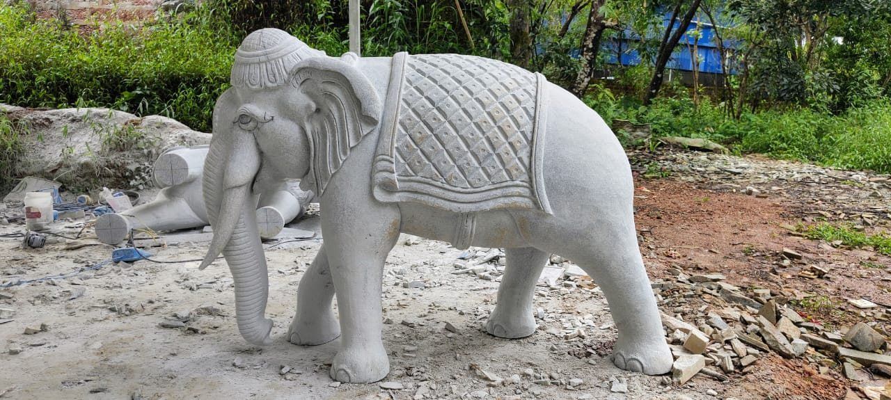 Life-size granite elephant sculpture with carved caparison