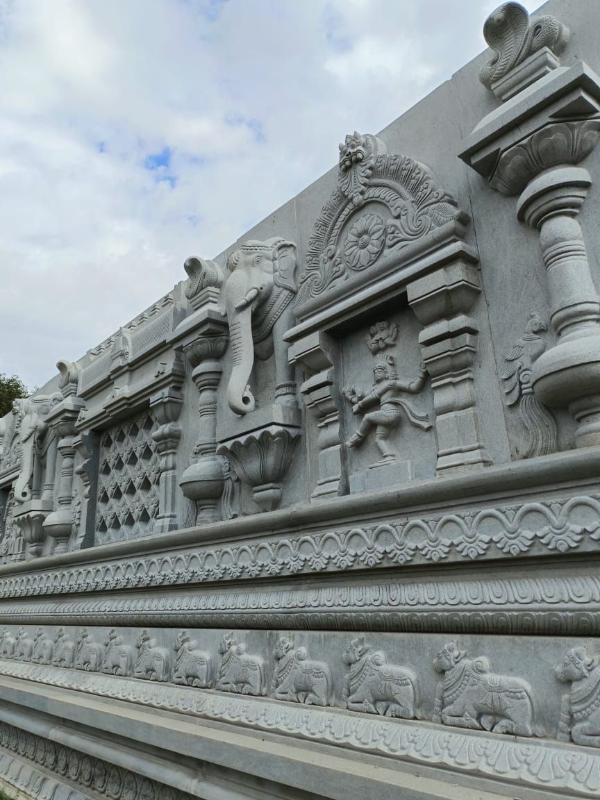 Carved temple wall course with elephant and Nataraja reliefs